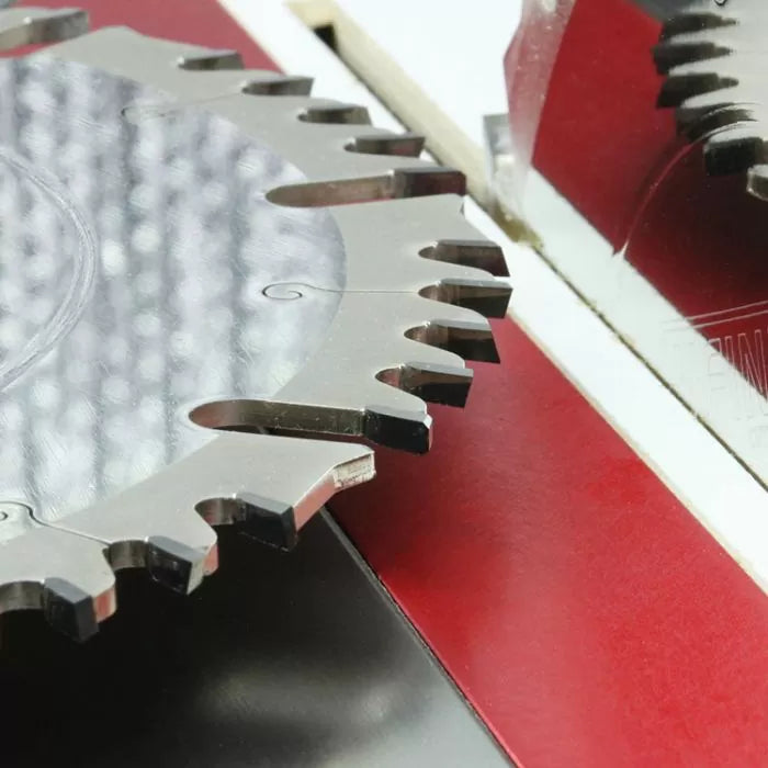 Close-up of carbide-tipped table saw blade in woodworking setup