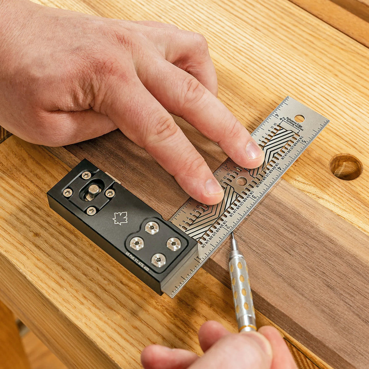 Precision woodworking square and marking gauge in use on wood surface