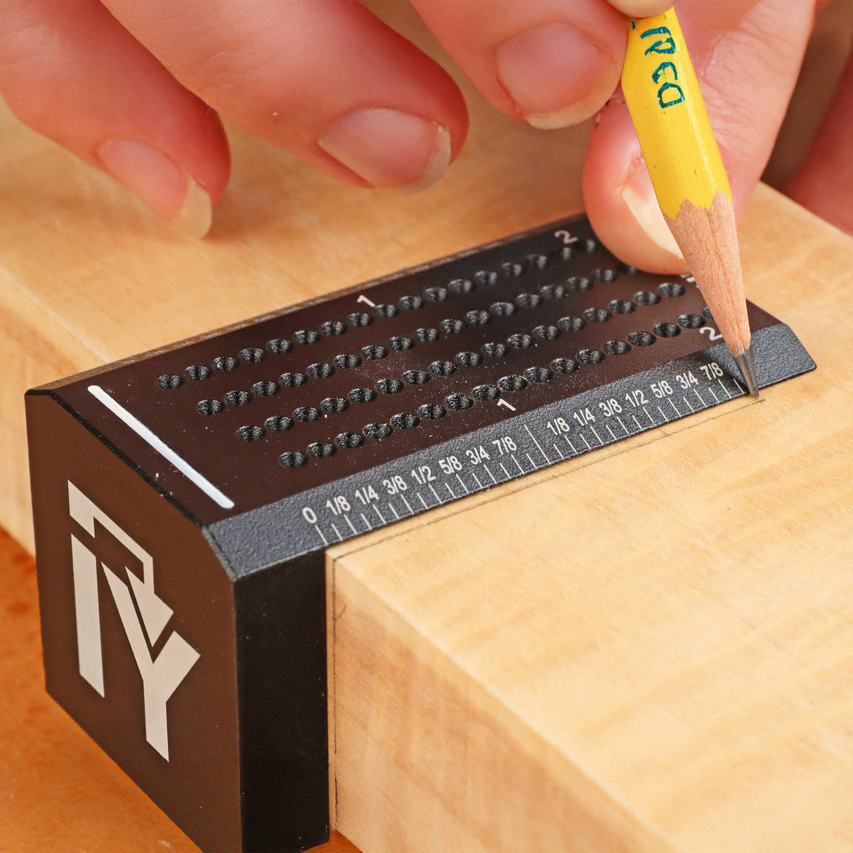 The bevelled edge of the square brings your pencil to the exact location on the wood.