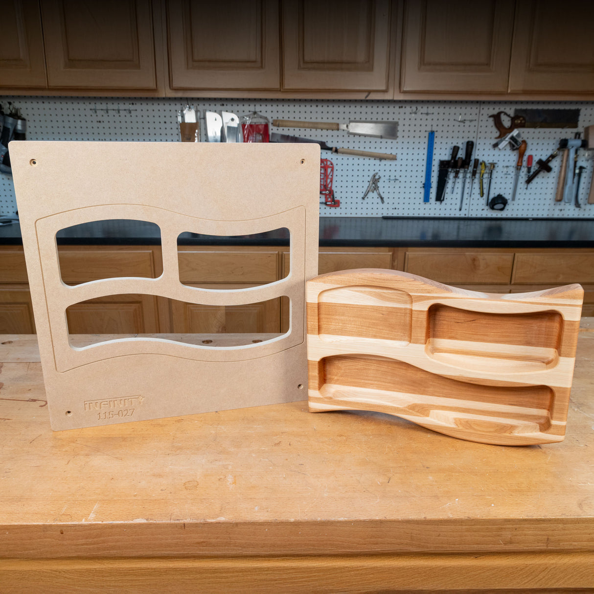 Woodworking tray template and finished wooden organizer on a workshop table