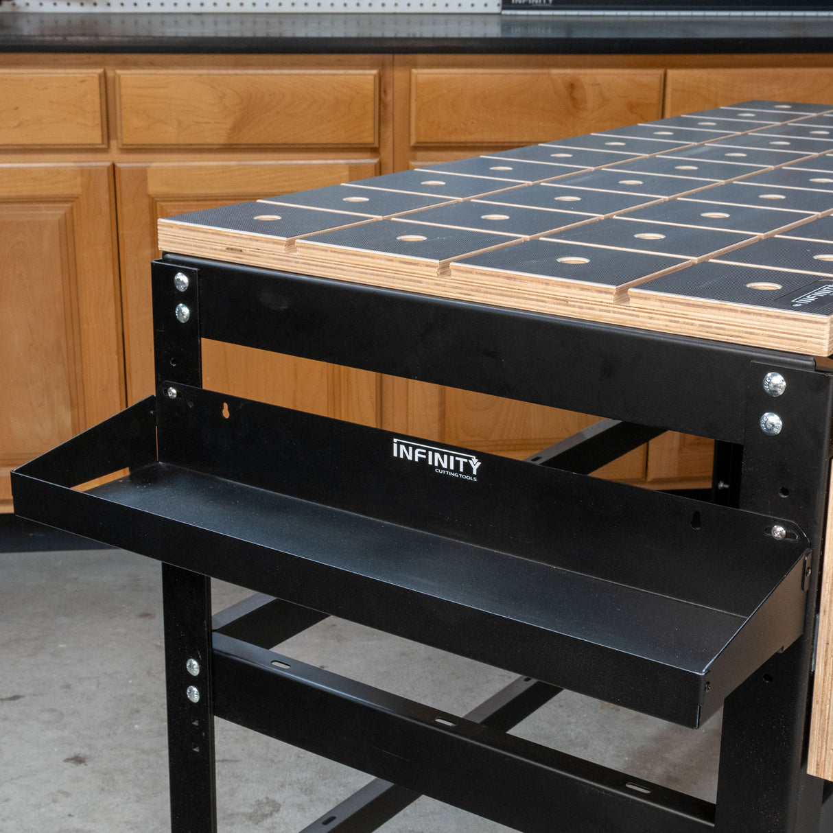 Black metal workbench with grid surface on a wooden cabinet background