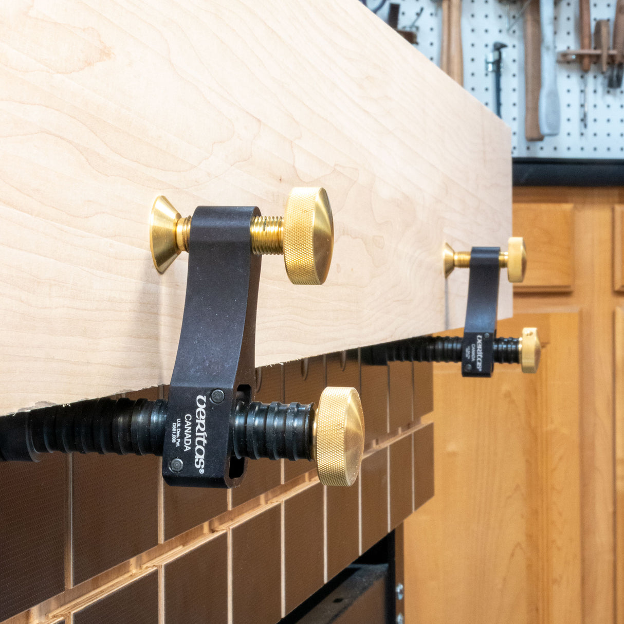 Closeup of Veritas surface clamps holding a board on a side skirt.