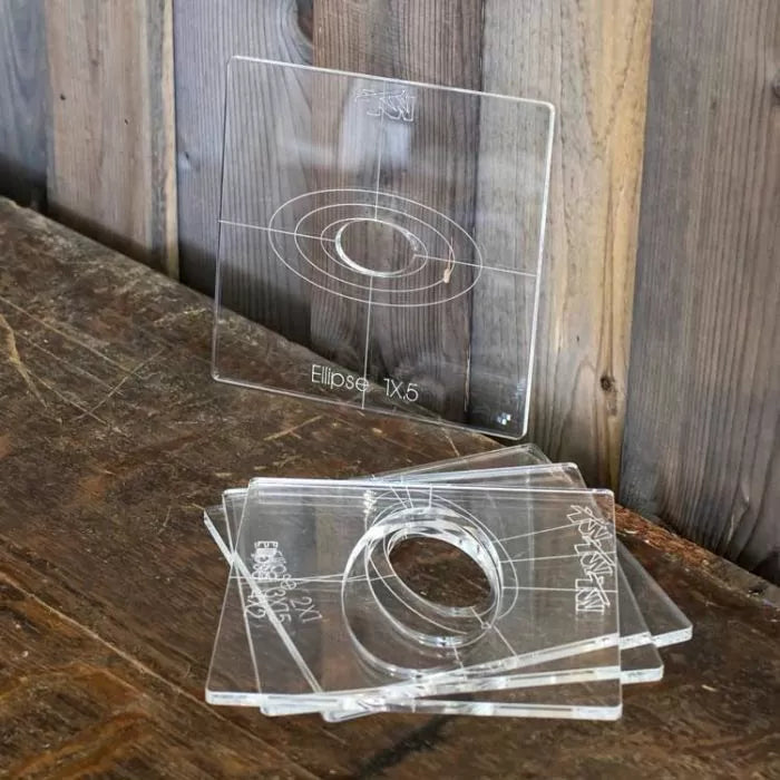 Clear acrylic ellipse router templates for woodworking on a rustic wooden table