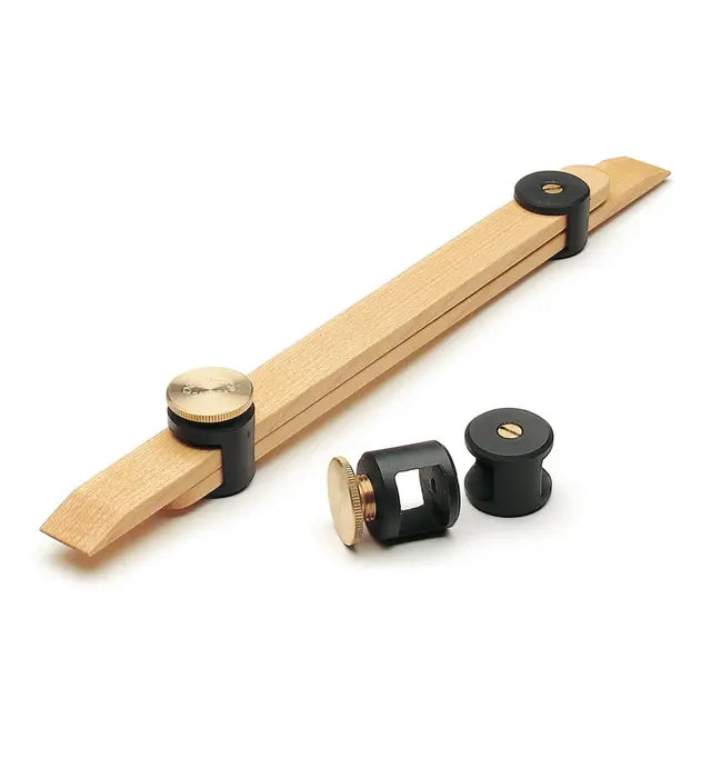 Woodworking marking gauge with adjustable brass knobs and black fittings on white background