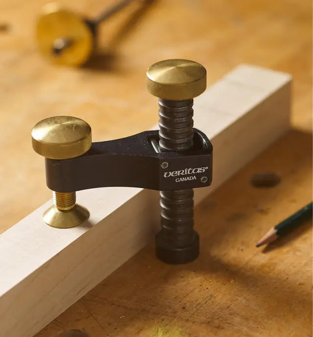 Veritas woodworking clamp on a workbench clamping a wooden board, precision tool