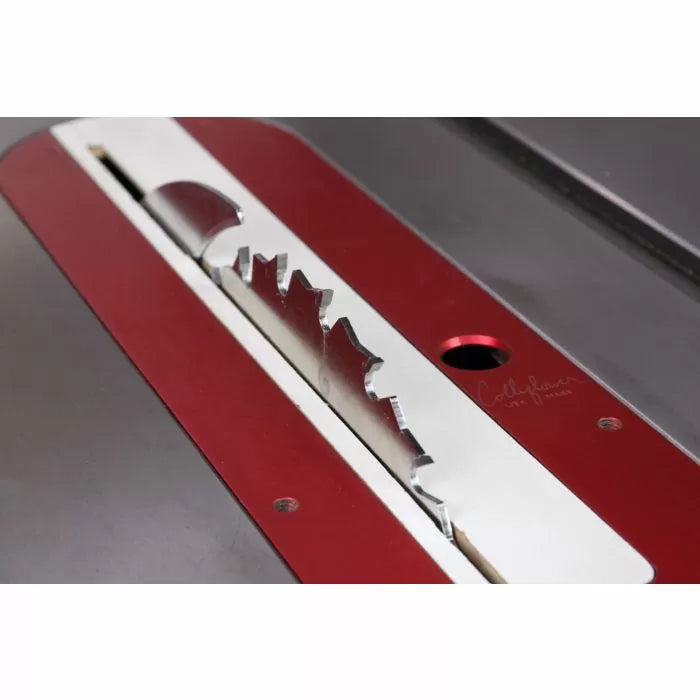 Close-up of a table saw blade set in a red and silver insert plate for woodworking