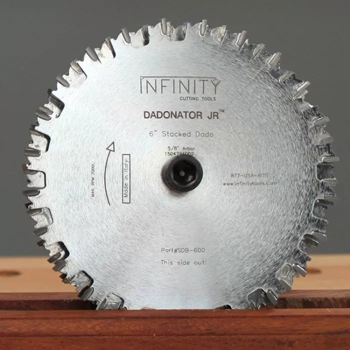 6-inch stacked dado saw blade with carbide teeth on a wooden surface, labeled Dadonator Jr.