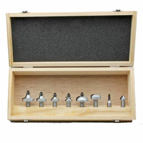 Woodworking router bit set in wooden case with foam padding, assorted bit shapes visible