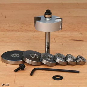 Woodworking router bit with multiple bearings, hex key, and screw on wood surface