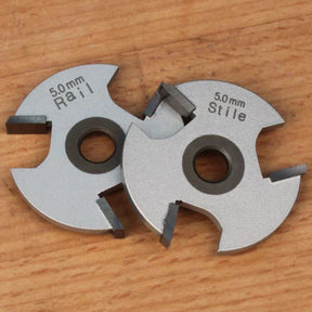 5mm rail and stile woodworking cutter blades on wood surface