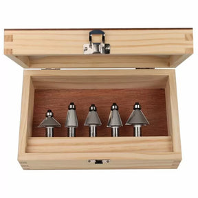 Woodworking router bit set in open wooden case, five metal bits organized in a row