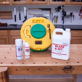 Woodworking blade and bit cleaning kit with rust remover sprays and cleaning supplies on bench.
