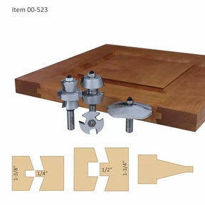 Cabinet door router bit set with carbide-tipped cutters and sample joint profiles on wood panel.