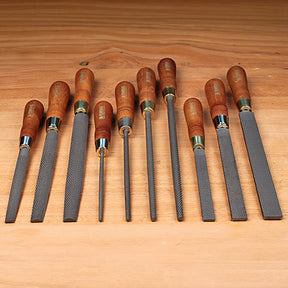 Set of woodworking rasps with wooden handles on a wooden surface