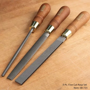 Three-piece fine cut rasp set with wooden handles on a woodworking bench