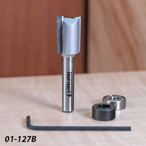 Woodworking router bit set with bearings, hex key, and straight carbide cutting tool on a table