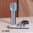 Carbide woodworking router bit with bearings and hex key on a wood surface, 01-690B.