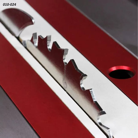 Close-up of table saw blade in red and silver insert plate for woodworking