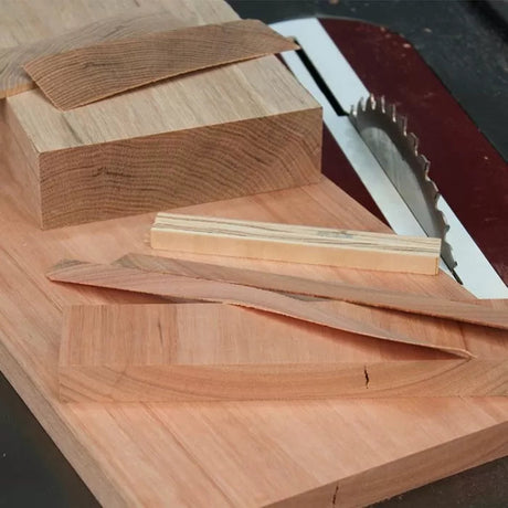 Woodworking table saw with hardwood blocks and freshly cut curved wood strips