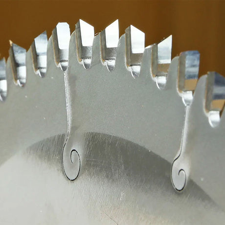 Close-up of carbide-tipped circular saw blade teeth for woodworking precision cuts