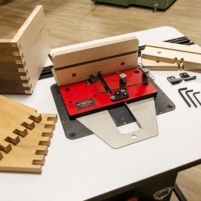Woodworking router table with wooden pieces on a white surface