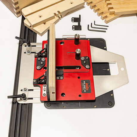 Router table with red base and wooden pieces on a white background