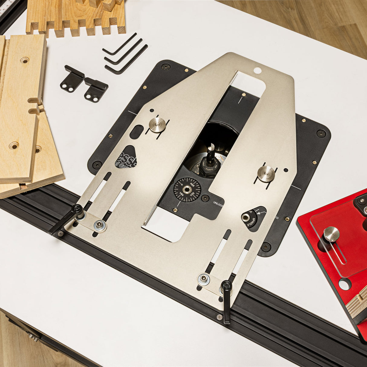Router table with various accessories on a white surface