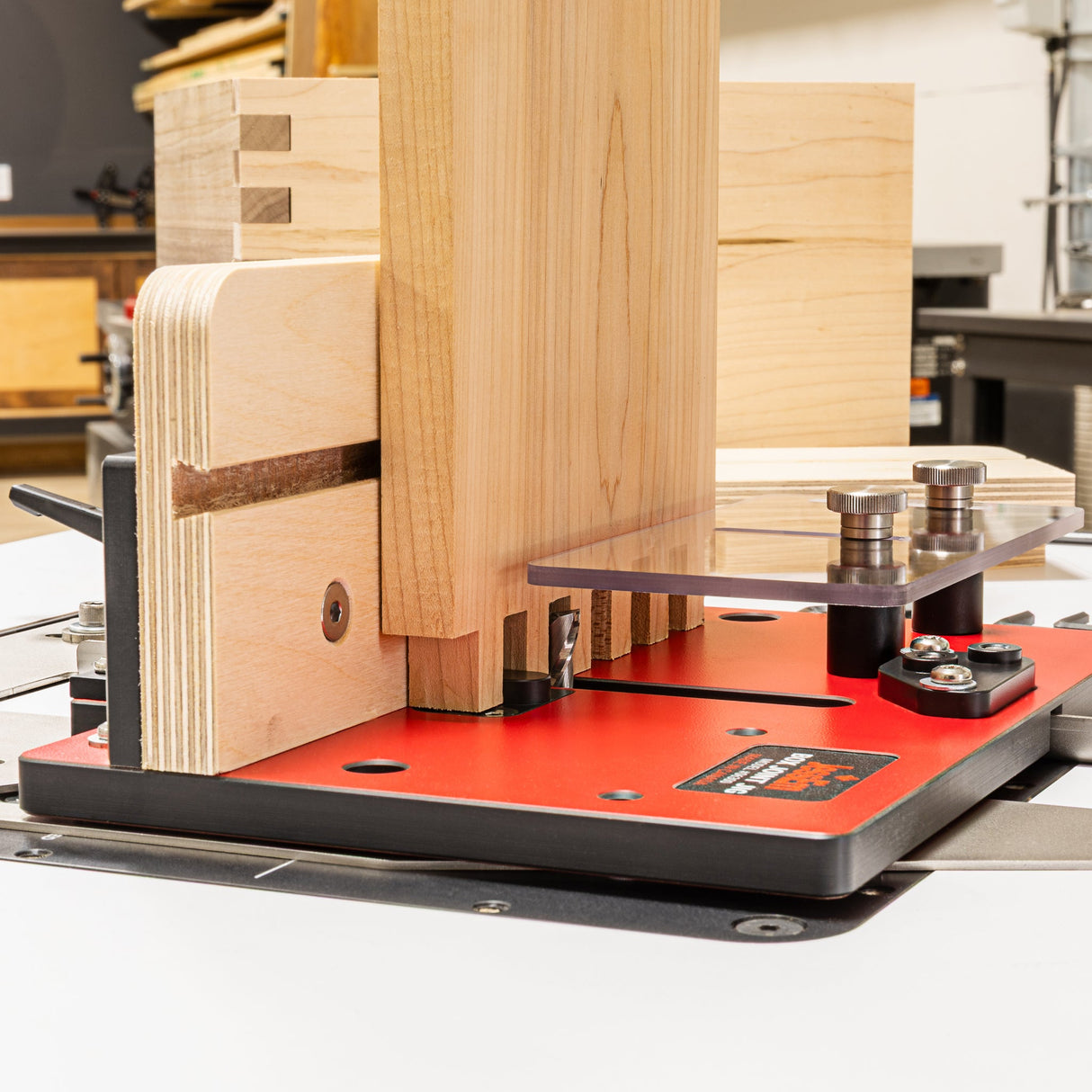 Woodworking machine with wooden pieces on a red platform