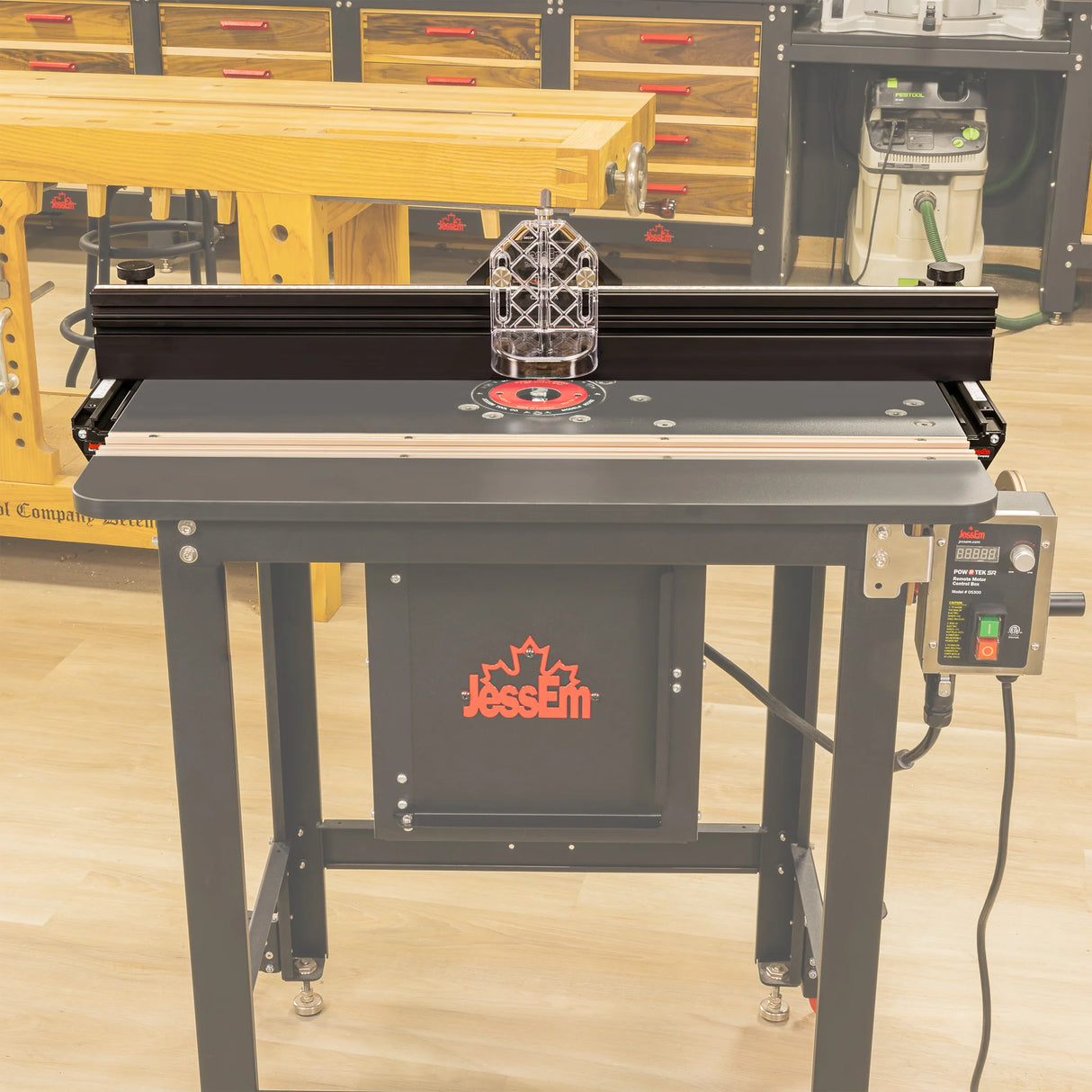 Professional router table with fence and safety guard in a woodworking workshop