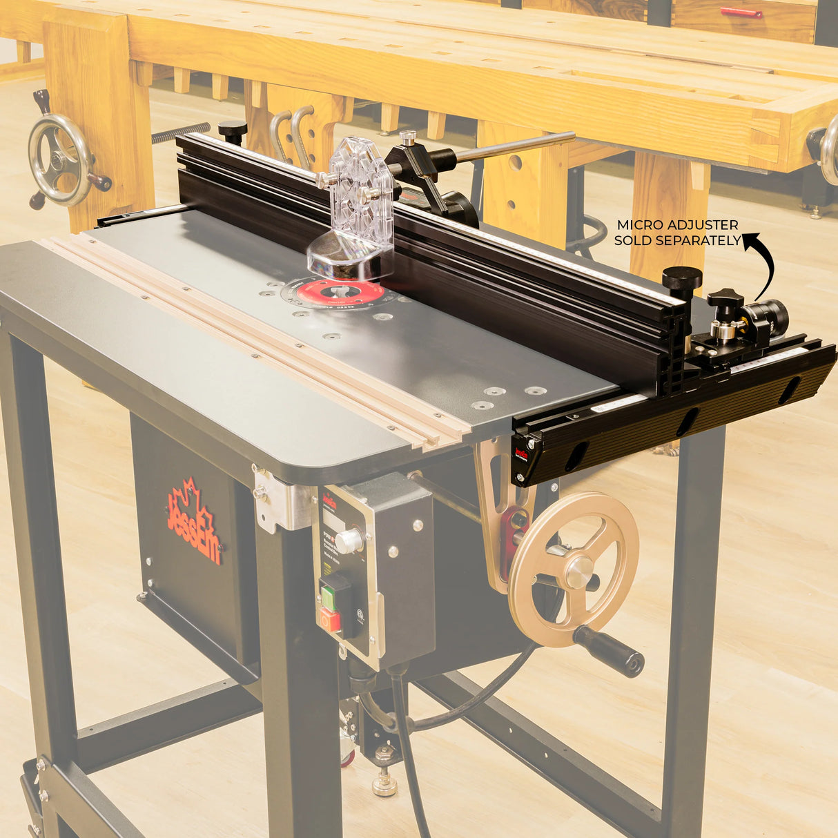 Router table with adjustable fence and clear guard in a woodworking shop setting