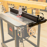 Router table with adjustable fence and clear guard in a woodworking shop setting