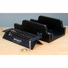 Router table dovetail jig with bit and guide bushing on wooden workbench