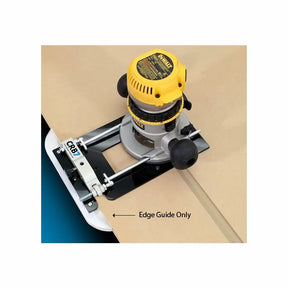 Router with edge guide attachment cutting straight line on wood panel