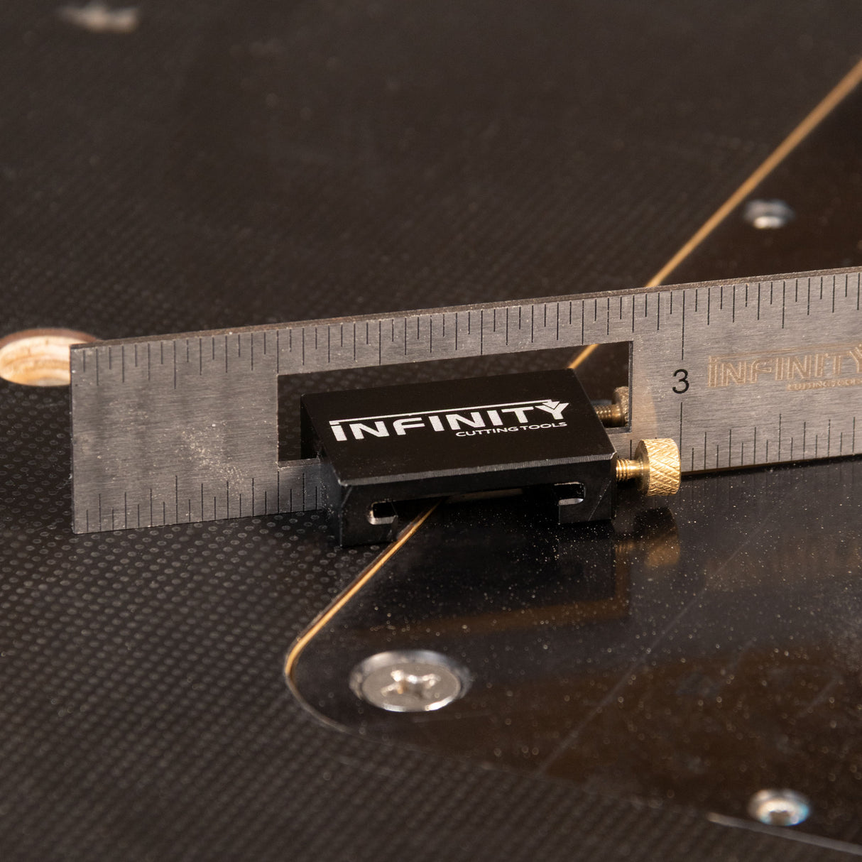 Infinity cutting tool with a ruler on a black background