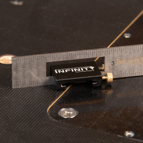 Infinity cutting tool with a ruler on a black background