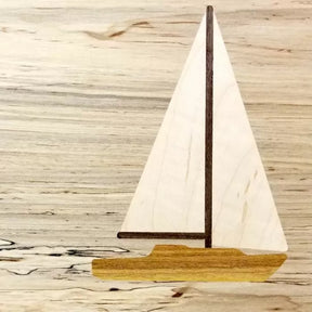 Wooden sailboat inlay with light and dark wood on a grain wood background, woodworking project