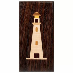 Wood inlay lighthouse design on a dark rectangular wood plaque, woodworking project example