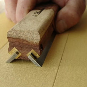 Woodworking marking gauge with dual blades creating precise lines on wood surface