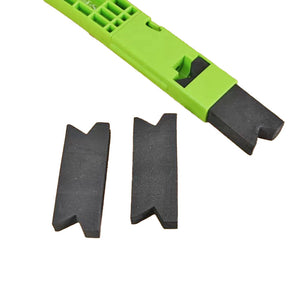 Green plastic woodworking push stick with two black V-notched replacement tips