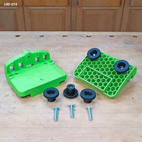 Green woodworking featherboard kit with knobs and bolts on a workbench in a workshop setting.