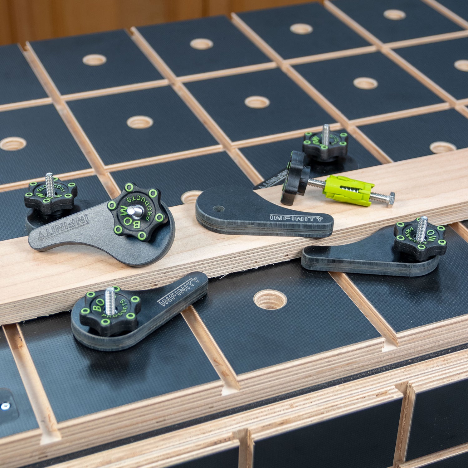 Eccentric cam clamps for woodworking on a perforated workbench with a wood board