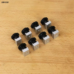Eight aluminum T-track knobs with black handles for woodworking jigs on a wooden surface