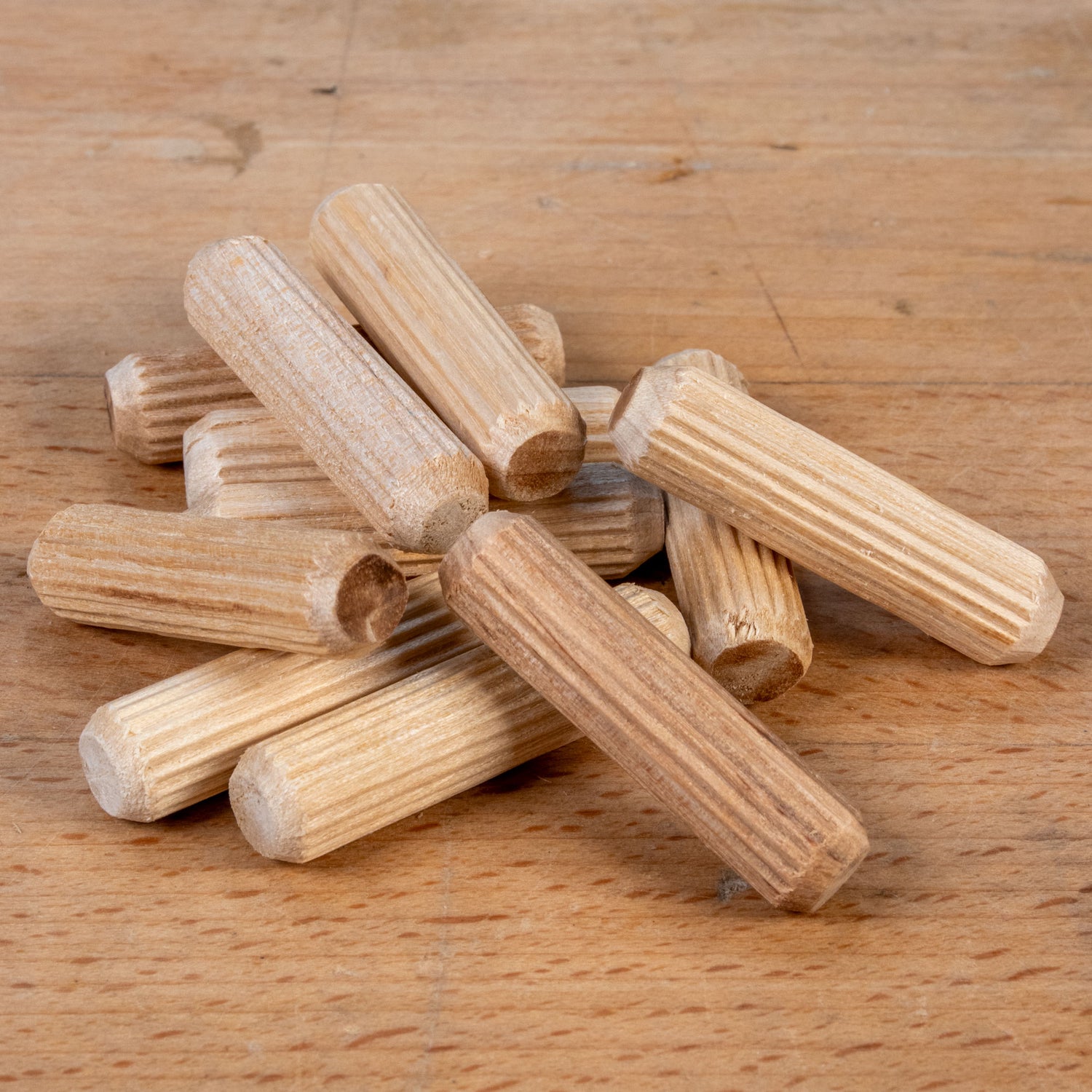 Stack of wooden dowels on a wooden surface