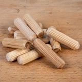 Stack of wooden dowels on a wooden surface