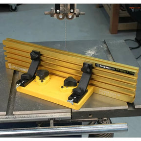 Magnetic bandsaw fence and featherboard on a metal table saw for woodworking.