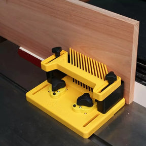 Yellow woodworking featherboard hold-down in use on table saw guiding wood board