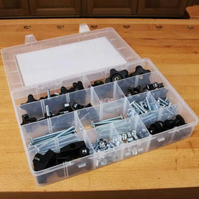 Woodworking jig hardware kit in clear organizer box on workbench