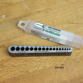 V-DrillGuide metal drill bit guide for woodworking on a workbench with storage case