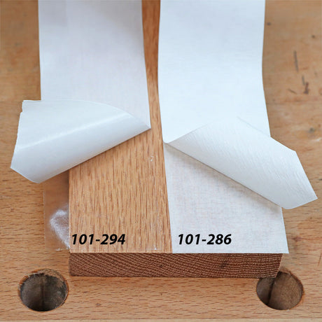 Double-sided adhesive tape rolls, 101-294 and 101-286, peeled on woodwork bench.