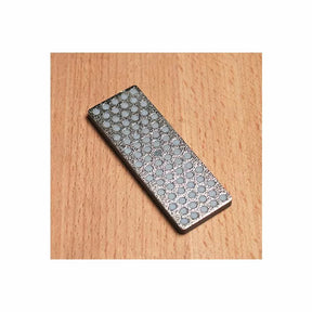 Diamond sharpening stone with dot pattern on wood surface for woodworking tools